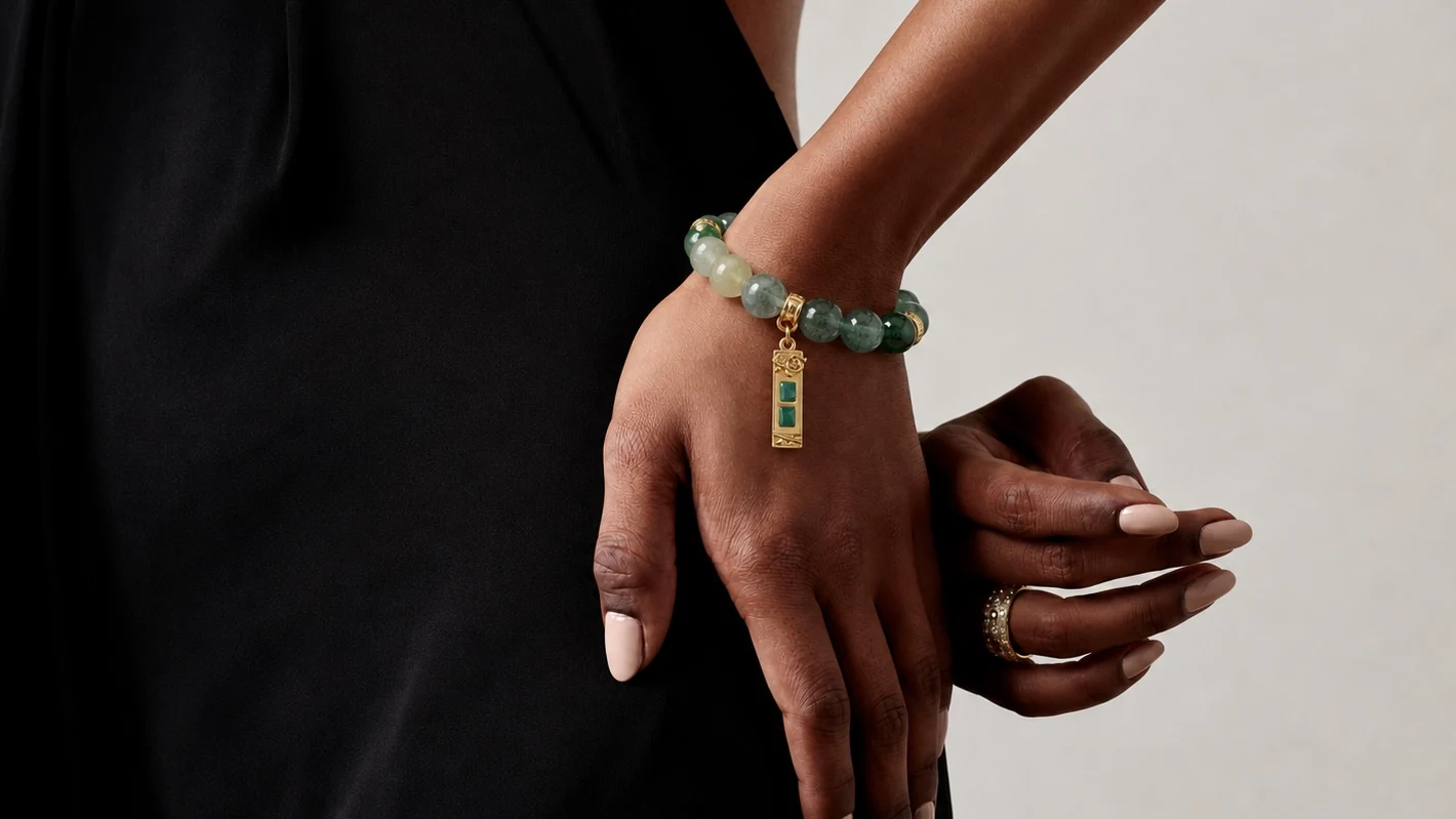 A green crystal bracelet worn on the wrist
